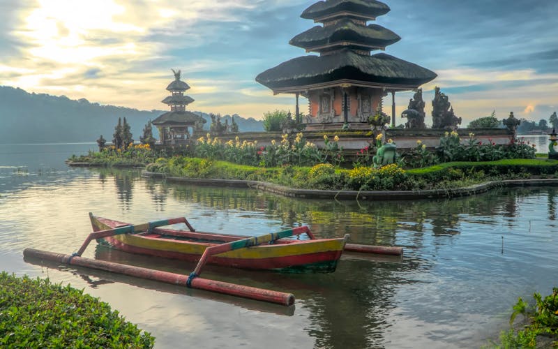 Group of tourists exploring a Balinese temple surrounded by lush greenery
